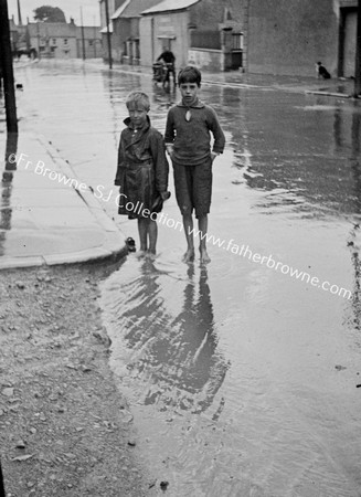 BOYS IN FLOODED STREET